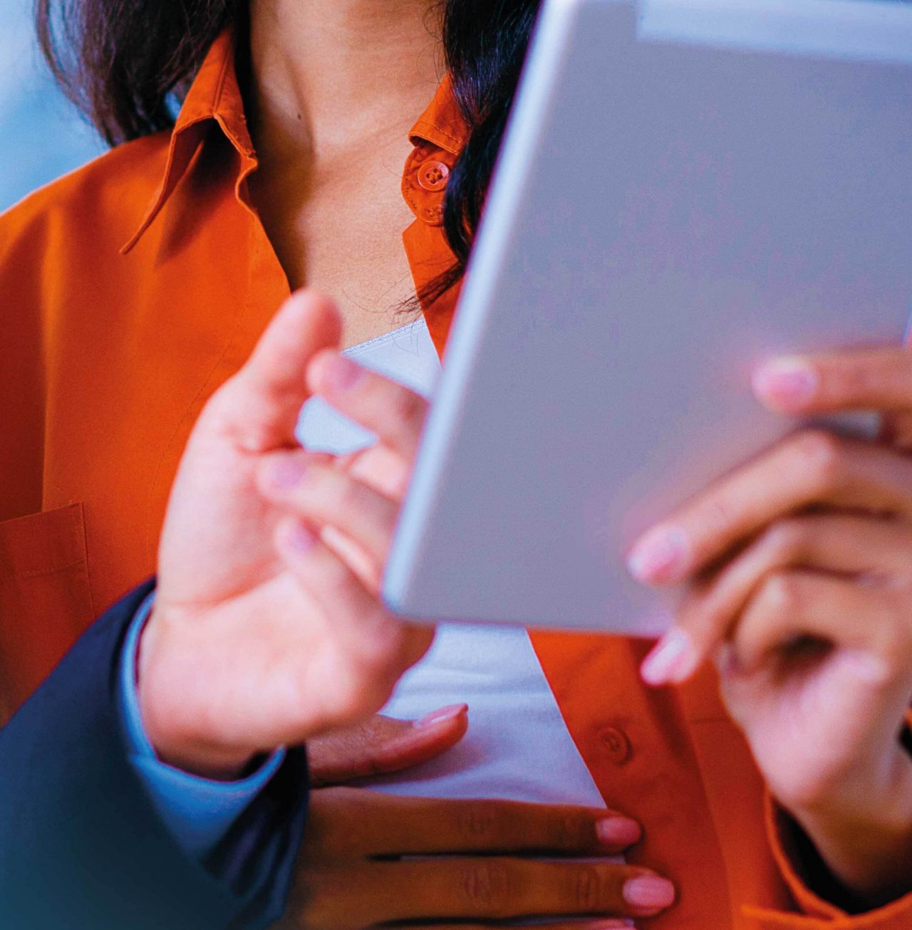 Mosaic image of two colleagues smiling and looking at tablet